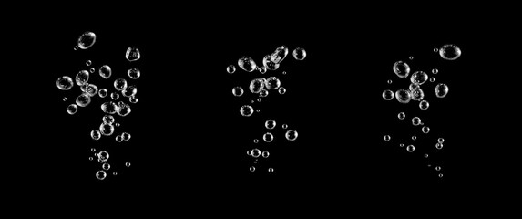 Water floating in the dark blue ocean, surrounded by bubbles and ripples, while the crystal clear water sparkles with small black and white water droplets.