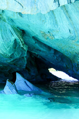Vertical image of Sculpted blue chapels of Marble caves or Cuevas de Marmol at turquoise General Carrera Lake. Location Puerto Sanchez, Chile