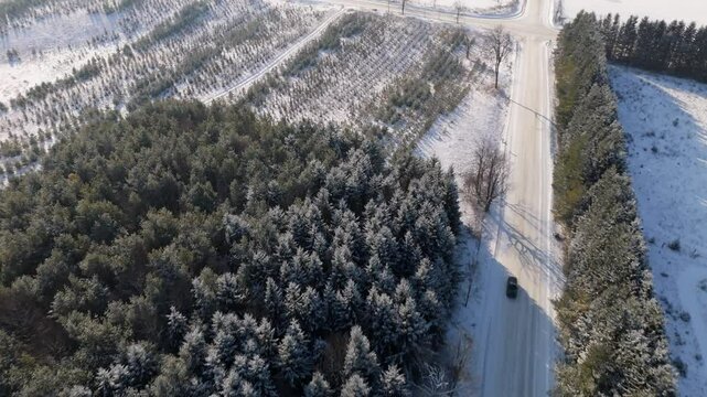 Car Driving On A Snow Covered Road In A Rural Winter Landscape In Caledon, Ontario, Canada.
