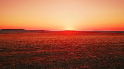 72.A dramatic view of a dry, barren field under a vivid red sunset, the horizon glowing as the sun dips low, highlighting the severity of drought conditions.