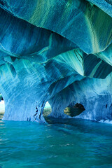Vertical image of Sculpted blue chapels of Marble caves or Cuevas de Marmol at turquoise General Carrera Lake. Location Puerto Sanchez, Chile