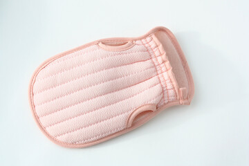 Women's pink washcloth in the shape of a mitten. Hygiene and spa concept.
