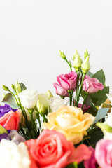 A beautiful bouquet of vibrant roses, eucalyptus, and delicate eustoma in white, pink, and purple hues, perfect for a summer anniversary or birthday celebration