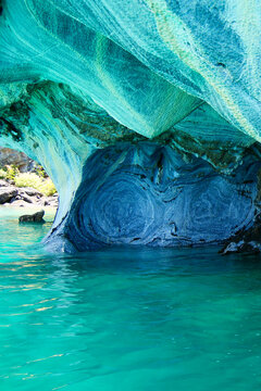 Vertical image of Sculpted blue chapels of Marble caves or Cuevas de Marmol at turquoise General Carrera Lake. Location Puerto Sanchez, Chile