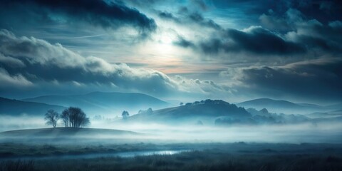 Obraz premium Serene Misty Valley at Dawn with Rolling Hills and Solitary Trees Under a Dramatic Sky