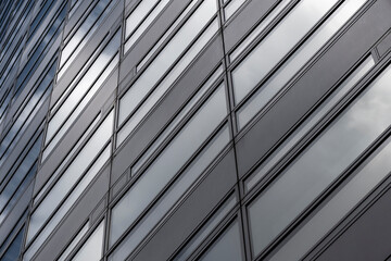 In this image, a diagonal view of a modern building facade creates an engaging visual interplay of lines and shapes that convey contemporary architectural aesthetics and elegance.