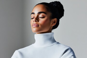 Obraz premium Woman in a white turtleneck sweater practices mindfulness in a serene indoor setting with closed eyes