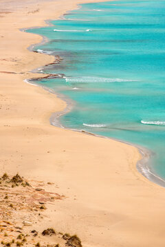 Detailed view of a white sand beach with turquoise water