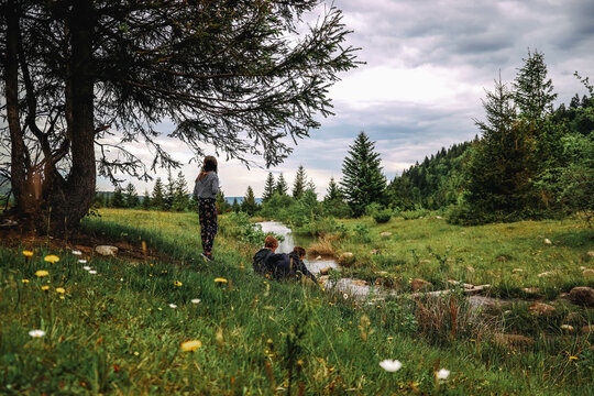 Three kids playing in the forest