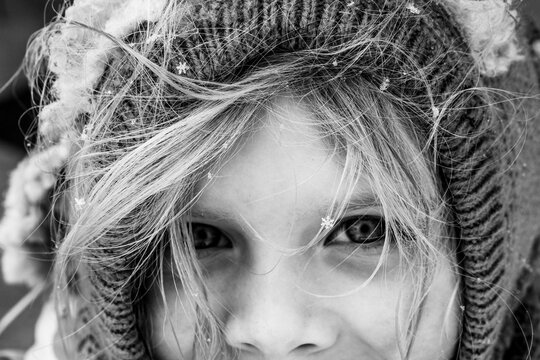 Close up of detailed snowflakes on wispy hair of child