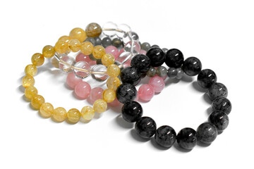 Crystal gemstones bracelet beads collection on white background. Healing, Love and Peaceful stones.
