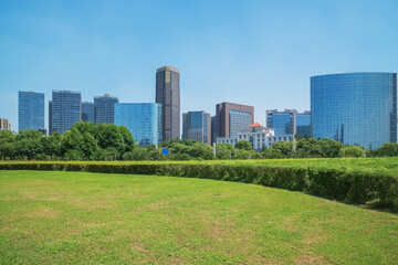 Obraz premium Modern urban architecture and large lawns at Qiushui Square in Nanchang, Jiangxi Province, China on April 1, 2024