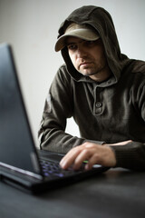 Man working on laptop. IT. Gamer. A computer hacker. Business on the Internet