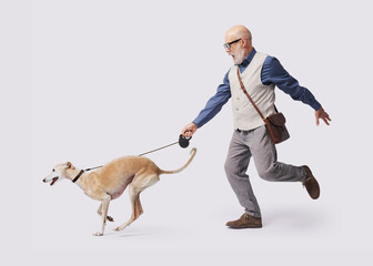 Mature man walking a disobedient dog