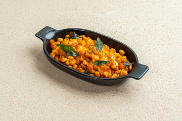 crispy fried corn with cheese sauce on black bowl with light background