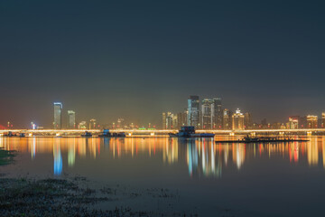 Fototapeta premium The urban skyline, hero bridge, and night view of Ganjiang River in Nanchang City, Jiangxi Province, China on April 1, 2024