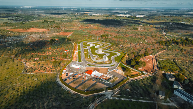 Aerial Race Kart Track: Kart Track. An expansive aerial view showcases a dynamic race track winding through a vibrant landscape. Santeramo In Colle Bari, Puglia, Italia - Powered by Adobe