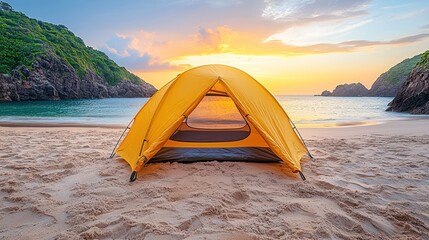 A yellow tent on a sandy beach at sunset, inviting relaxation and outdoor adventure.