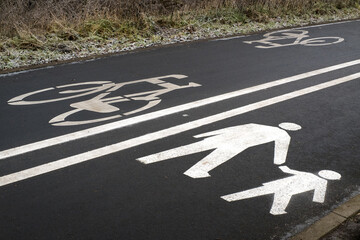 A pedestrian and bicycle path with designated traffic lanes, winter.
