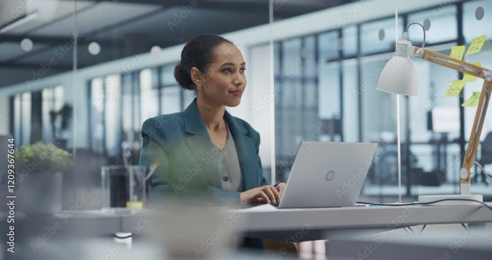 Poster young black businesswoman leads an online team meeting on laptop computer while in office. she provi