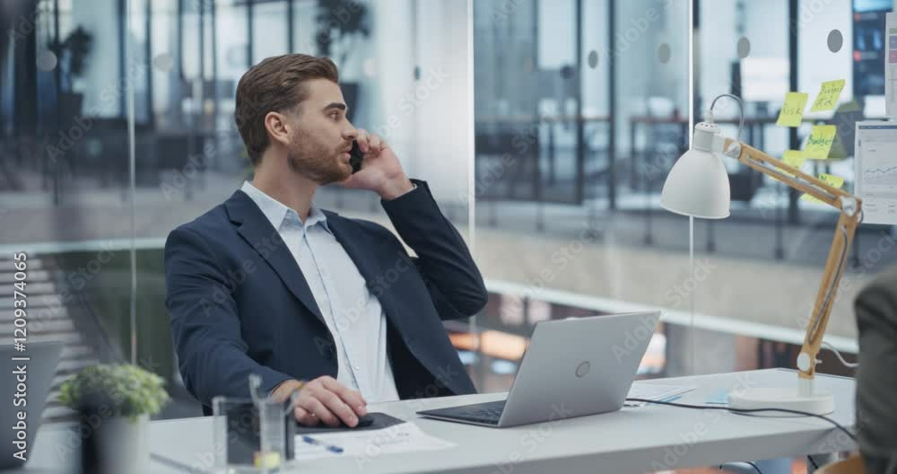 Poster sales representative closing a sale deal on a phone while updating customer information on laptop co