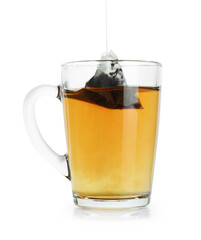 Putting tea bag into glass cup on white background