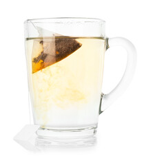 Tea bag in glass cup with hot drink isolated on white