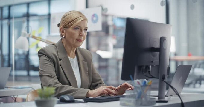 HR Manager Preparing for Job Interviews for Office Manager Position on a Desktop Computer. Female Assessing Candidate Skills and Experience in a Positive And Productive Work Environment