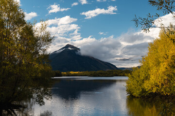 Scenic countryside with Glenorchy Lagoon and massive mountains in the background on a perfect summer evening with some clouds (Glenorchy, South Island, New Zealand)
