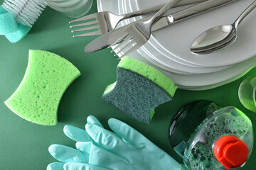 Product, tools, dishes and cutlery on green background top view