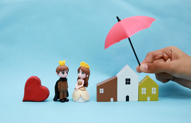 bride and house protected by umbrella - Concept of life, home and auto insurance