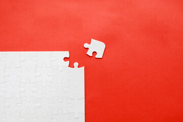 White details of puzzle on red background. Business strategy, teamwork.