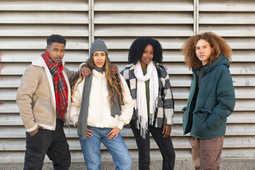 Fototapeta premium Group of young people posing together outdoors in winter clothes