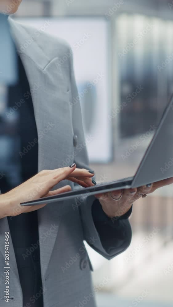 Aufkleber Vertical Screen: Anonymous Caucasian Woman Using Laptop while Standing in an Office Behind a Glass Wall. Manager Browsing Internet, Checking Emails, Typing a Message, Researching Online Data