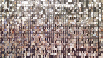 Decorative wall with ornament of shiny mirror silver squares.