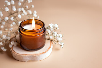 Burning candle and white gypsophila flowers