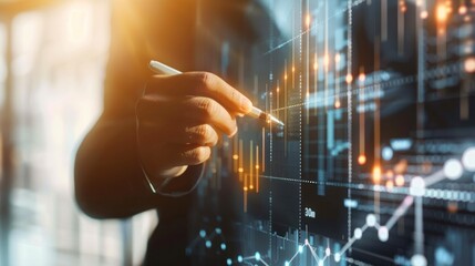 Analyst pointing at data graph on screen in office