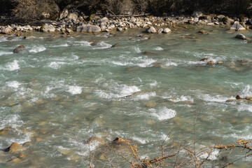 Kabardino-Balkaria. Chegem Gorge 2024. Stormy and foaming emerald waters of Chegem River flow between steep cliffs with grottoes created by nature. Chegem River in means 