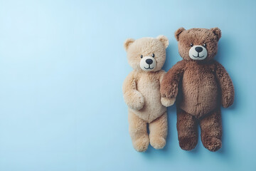Obraz premium Two adorable teddy bears holding hands on light blue background, symbolizing friendship and love. Their soft fur and cheerful expressions evoke warmth and comfort