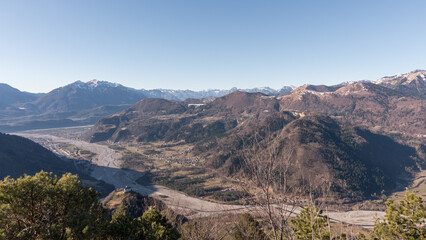 Fototapeta premium Panorama of the Carnic mountains from the top of Mount Giaideit, Friulian Alps. Sunny day and view of the Pieve di San Floriano.