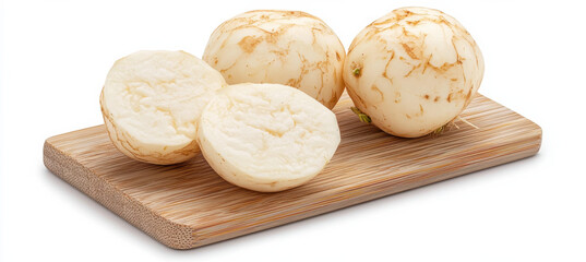 Fresh jicama on wooden cutting board, whole and halved isolated design