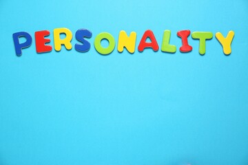 Word Personality made of colorful letters on light blue background, top view. Space for text