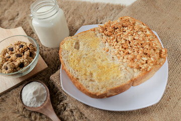 Bread with peanut and butter spread on a table for breakfast	
