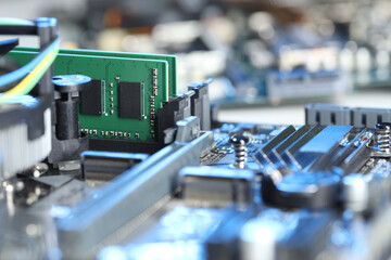 Computer motherboard with RAM chip as background, closeup. Electronic engineering