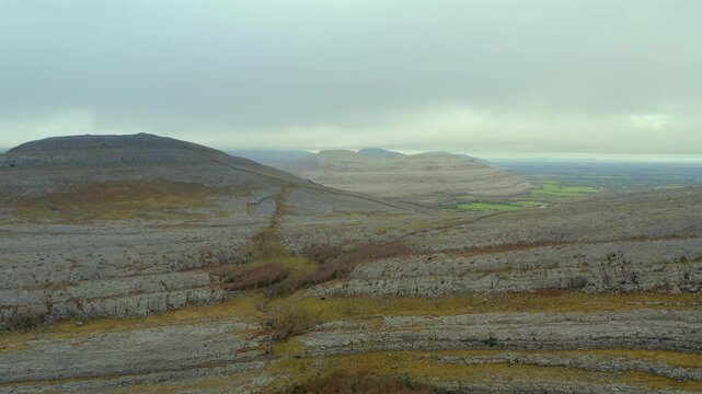 Dramatic landscape of the Burren's most iconic hills under a misty sky. Ireland
