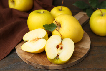 Fresh ripe yellow apples on wooden table, closeup