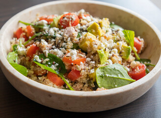 Close-up of a vibrant and nutritious salad made with quinoa, avocado, mixed seeds, and cheese, packed with protein and healthy fats for a wholesome meal