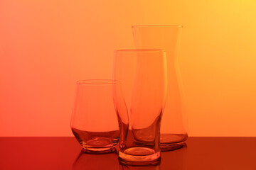Empty glass and jug on table, color tone effect