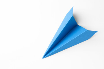 One handmade light blue paper plane on white background, top view. Space for text