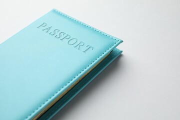 Passport in blue cover on light background, closeup. Space for text